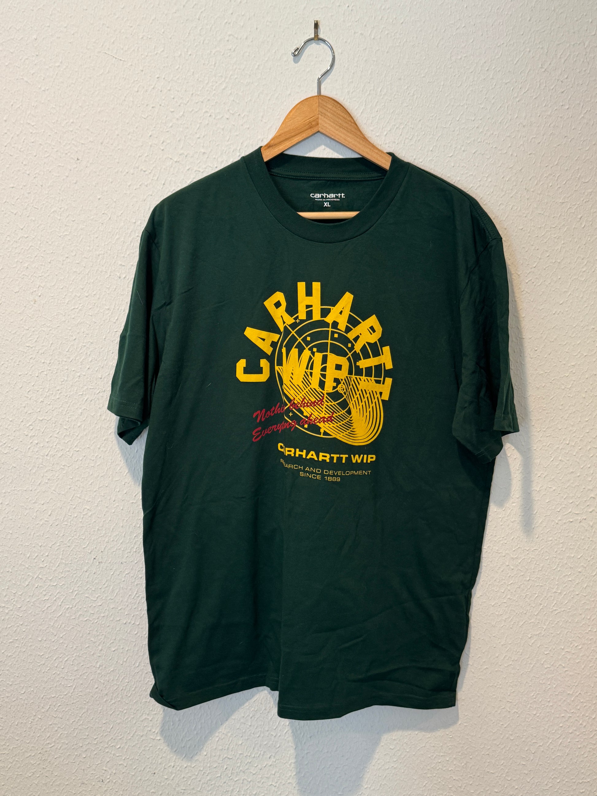 Green t-shirt with yellow graphic design on a white background