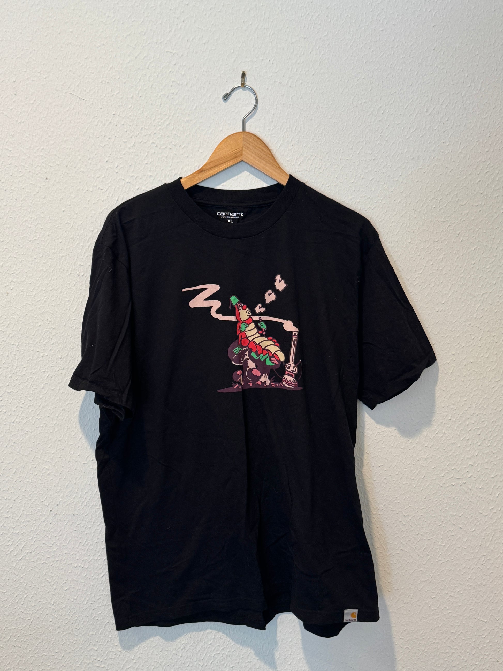 Black t-shirt with graphic design on a white background