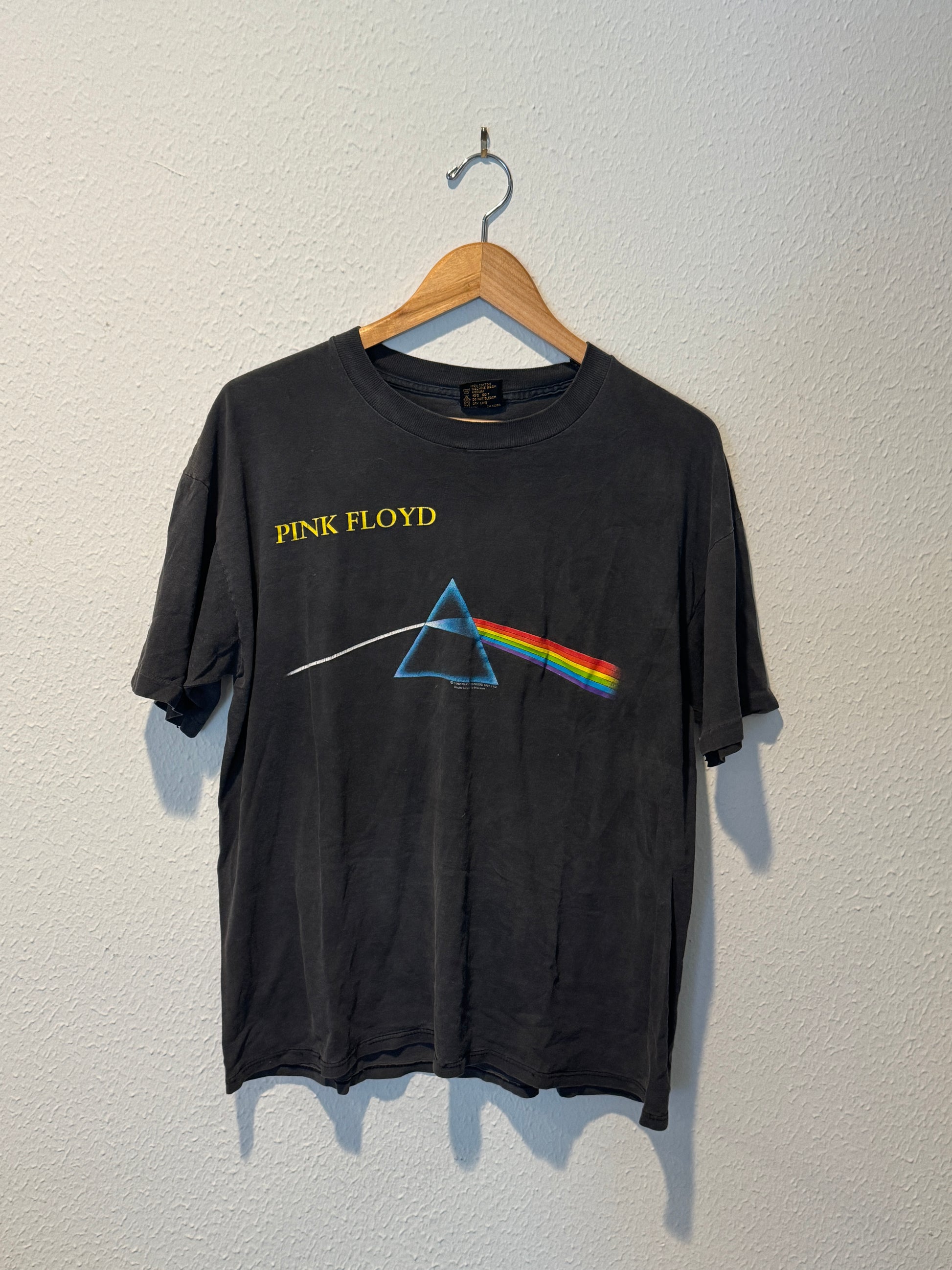Black t-shirt with Pink Floyd logo on a white background