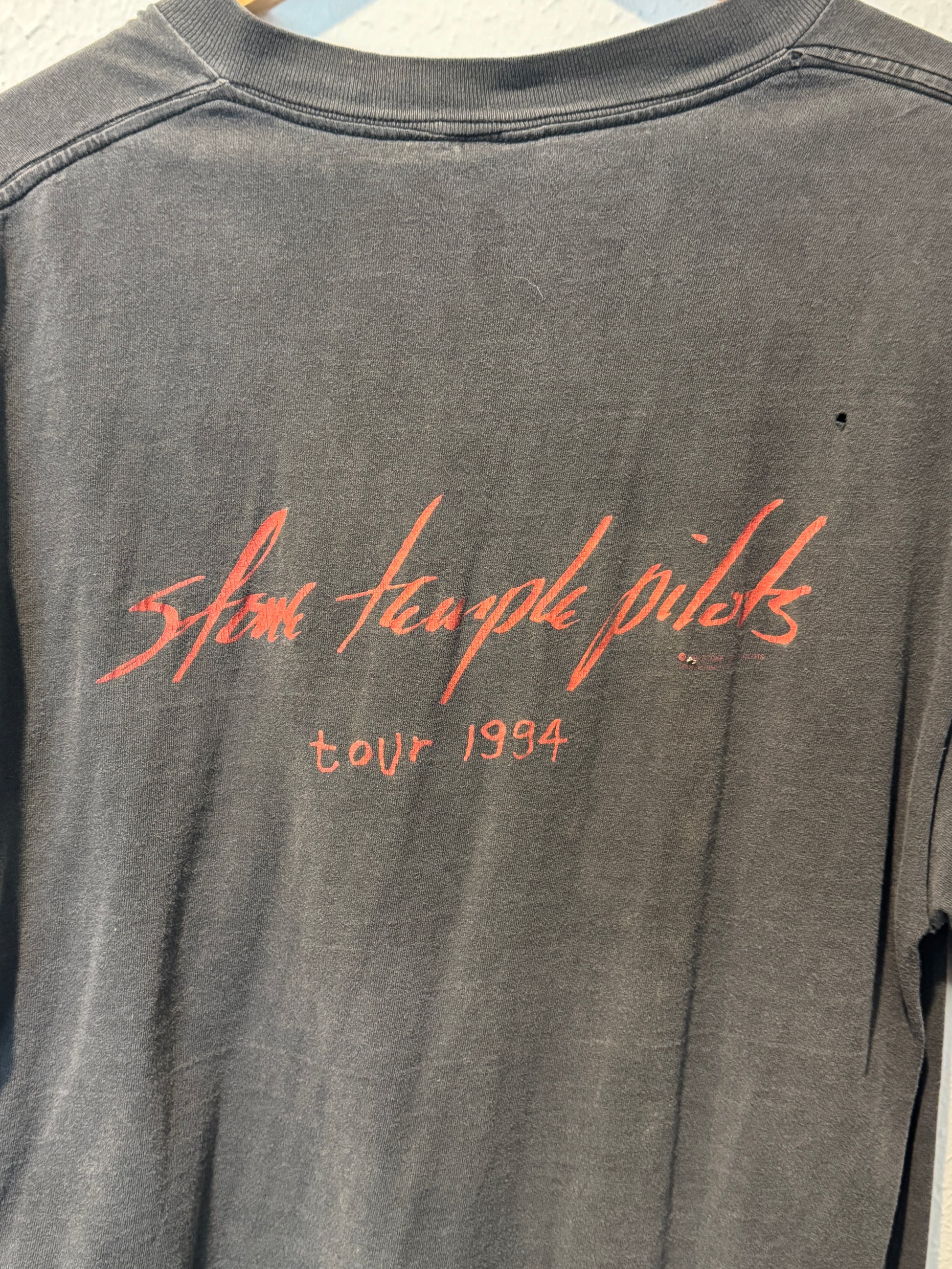 Gray tank top with red text on a plain background vintage