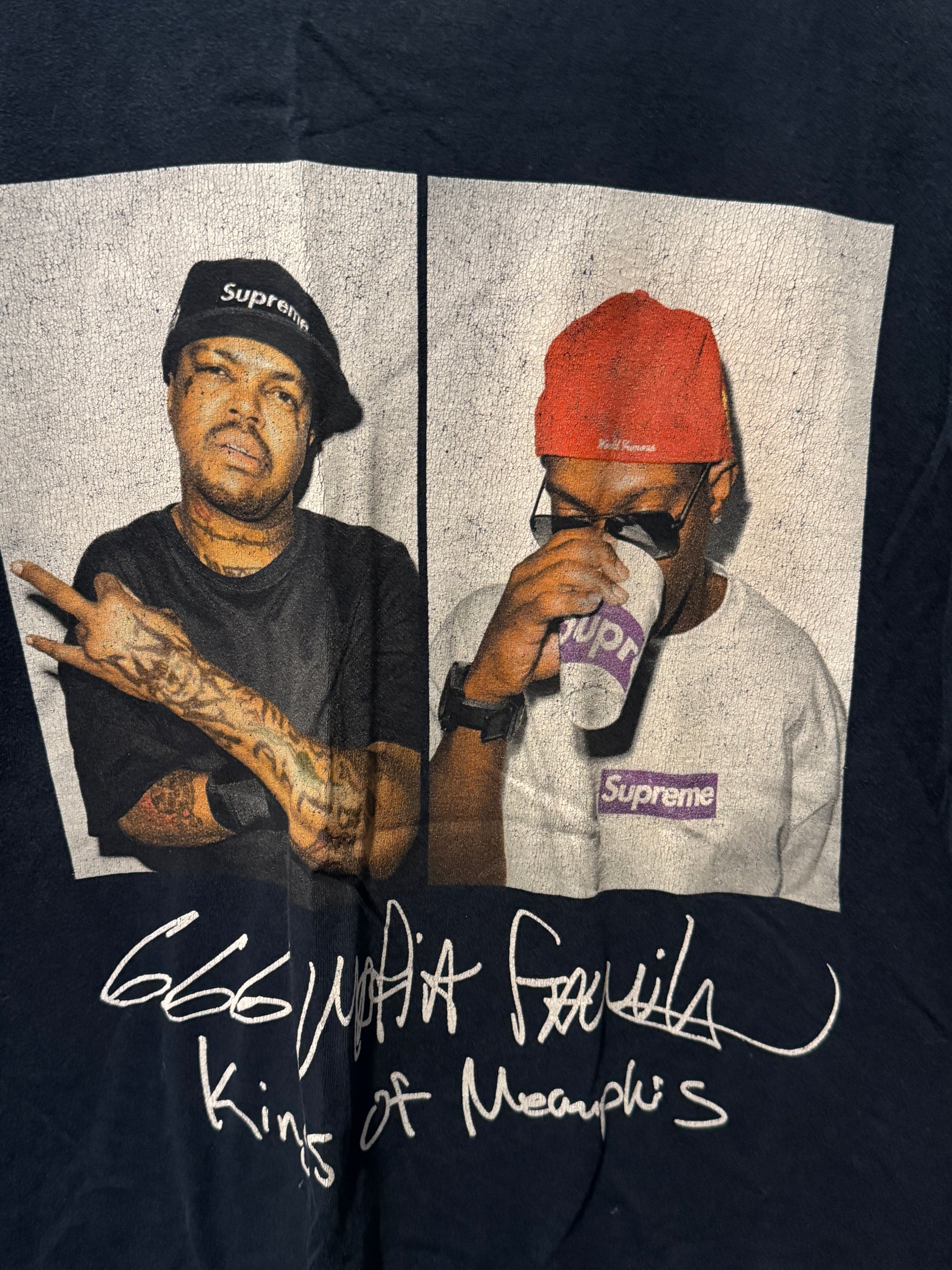 T-shirt with a graphic of a person wearing a Supreme cap and a signature on a dark background
