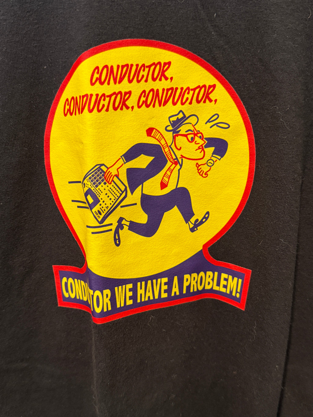 Sticker with a conductor graphic and text on a black background