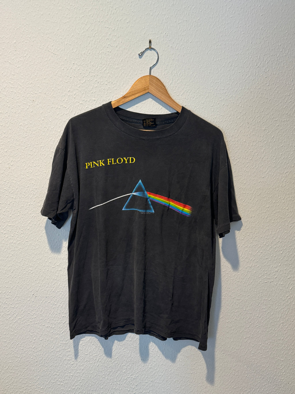 Black t-shirt with Pink Floyd logo on a white background